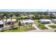 Exterior view of a waterfront home featuring a well-manicured lawn and palm trees at 3100 Magnolia Way, Punta Gorda, FL 33950