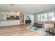 Open-concept living area with wood floors seamlessly connecting the kitchen and living spaces at 3100 Magnolia Way, Punta Gorda, FL 33950