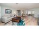 Spacious living room with wood floors, neutral tones, and abundant natural light at 3100 Magnolia Way, Punta Gorda, FL 33950