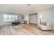 Inviting living room featuring light walls, wood floors, and a comfortable seating area at 3100 Magnolia Way, Punta Gorda, FL 33950