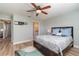 Comfortable main bedroom offers a ceiling fan and warm lighting at 3100 Magnolia Way, Punta Gorda, FL 33950