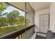 This condo features a cozy balcony with outdoor seating and a serene view of trees and landscaping at 311 Garvin St # 401C, Punta Gorda, FL 33950