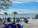 Relaxing beach scene with numerous chairs and tables filled with people enjoying the waterfront view on a sunny day at 311 Garvin St # 401C, Punta Gorda, FL 33950