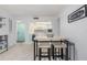 Dining area featuring a table with seating for four people, located adjacent to the kitchen, and a colorful entrance door at 311 Garvin St # 401C, Punta Gorda, FL 33950