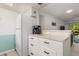 A well-lit kitchenette area featuring a refrigerator, coffee maker, and ample storage space for kitchen essentials and supplies at 311 Garvin St # 401C, Punta Gorda, FL 33950