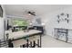 Bright living room featuring a ceiling fan, comfortable seating, and sliding doors to a private balcony with treetop views at 311 Garvin St # 401C, Punta Gorda, FL 33950