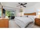 Comfortable main bedroom featuring a ceiling fan, balcony access, and a serene atmosphere for relaxation and rest at 311 Garvin St # 401C, Punta Gorda, FL 33950