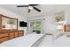 Cozy main bedroom featuring a ceiling fan, dresser, and balcony access, providing a peaceful retreat within the home at 311 Garvin St # 401C, Punta Gorda, FL 33950