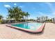 Community pool area with chairs and palm trees at 311 Garvin St # 401C, Punta Gorda, FL 33950