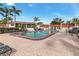 Inviting community pool surrounded by seating, palm trees, and access to building amenities at 311 Garvin St # 401C, Punta Gorda, FL 33950