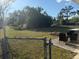 Large, grassy backyard with a fire pit, and patio furniture for relaxing or entertaining at 3209 Sunrise Trl, Port Charlotte, FL 33952