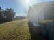Spacious backyard featuring a lush lawn, storage area, and lots of space to play at 3209 Sunrise Trl, Port Charlotte, FL 33952