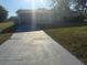 Single story home with a well-maintained front yard and driveway at 3209 Sunrise Trl, Port Charlotte, FL 33952