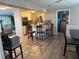 Open floorplan features eat-in kitchen with breakfast bar, stainless appliances, and wood flooring at 3209 Sunrise Trl, Port Charlotte, FL 33952