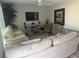 Inviting living room with hardwood floors, comfortable seating, and a large window at 3209 Sunrise Trl, Port Charlotte, FL 33952