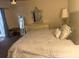 Comfortable main bedroom featuring a large bed, dresser, and ample closet space at 3209 Sunrise Trl, Port Charlotte, FL 33952