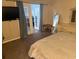 Comfortable main bedroom featuring a large bed, dresser, and adjacent room access at 3209 Sunrise Trl, Port Charlotte, FL 33952
