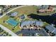 Drone shot of condo with pool, tennis court, boat dock, convenient parking, and lush landscaping at 3256 White Ibis Ct # 13B, Punta Gorda, FL 33950