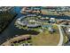 Beautiful aerial view of condo community including tennis court, pool, and docks for boating at 3256 White Ibis Ct # 13B, Punta Gorda, FL 33950