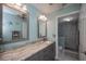 Bathroom featuring a stone counter top vanity and tiled walk-in shower at 3256 White Ibis Ct # 13B, Punta Gorda, FL 33950