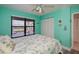 Serene bedroom with plenty of natural light from a big window and white closet doors at 3256 White Ibis Ct # 13B, Punta Gorda, FL 33950