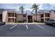 Tan condominium with parking spaces and palm trees, providing a convenient and appealing exterior at 3256 White Ibis Ct # 13B, Punta Gorda, FL 33950