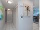 Bright hallway with closet, leading to the living area and kitchen, provides ample storage and easy access at 3256 White Ibis Ct # 13B, Punta Gorda, FL 33950