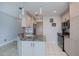 A well-lit kitchen features a gray granite countertop, island with a sink, and stainless steel appliances at 3256 White Ibis Ct # 13B, Punta Gorda, FL 33950