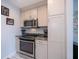 A functional kitchen boasts stainless steel appliances, lots of storage, and gray granite countertops at 3256 White Ibis Ct # 13B, Punta Gorda, FL 33950