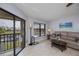 Inviting living room with water views from the sliding door and a comfortable sofa at 3256 White Ibis Ct # 13B, Punta Gorda, FL 33950