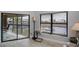 Bright living room featuring large windows with canal views and tile flooring at 3256 White Ibis Ct # 13B, Punta Gorda, FL 33950
