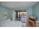 Bedroom with sliders to screened porch and neutral decor at 3256 White Ibis Ct # 13B, Punta Gorda, FL 33950