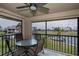 Screened-in patio with a table and seating overlooking the landscaped grounds and canal at 3256 White Ibis Ct # 13B, Punta Gorda, FL 33950