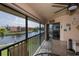 Screened-in porch with seating area overlooking the canal at 3256 White Ibis Ct # 13B, Punta Gorda, FL 33950