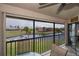 Screened-in porch with seating overlooking the canal and green space at 3256 White Ibis Ct # 13B, Punta Gorda, FL 33950