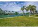 Enjoy a match at this sunny community tennis court surrounded by lush greenery and palm trees at 3256 White Ibis Ct # 13B, Punta Gorda, FL 33950
