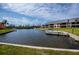 Beautiful waterfront view of the condos and boat docks on a sunny day at 3256 White Ibis Ct # 13B, Punta Gorda, FL 33950