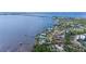 Stunning aerial view of waterfront property with direct bay access, surrounded by lush landscaping and a pristine shoreline at 4381 Northshore Dr, Punta Gorda, FL 33980