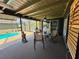 Comfortable back porch includes a seating area, grill, and backyard pool, ideal for outdoor entertaining at 4381 Northshore Dr, Punta Gorda, FL 33980