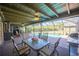 Inviting covered patio with dining furniture, ceiling fan and view to the pool at 4381 Northshore Dr, Punta Gorda, FL 33980