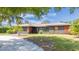 Charming single Gathering home featuring a well-maintained lawn and mature shade trees, and unique architectural details at 4381 Northshore Dr, Punta Gorda, FL 33980