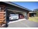 Attached two-car garage accommodating a Silverado truck and red Mazda at 4381 Northshore Dr, Punta Gorda, FL 33980