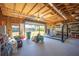 Well-lit garage featuring a car lift, storage shelves, an open garage door, and lawn equipment inside at 4381 Northshore Dr, Punta Gorda, FL 33980