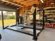 Inside this spacious garage featuring a car lift, storage shelves, and bright lighting at 4381 Northshore Dr, Punta Gorda, FL 33980