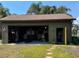 View of the exterior of this spacious garage with an open door showing the workshop area and lawn equipment at 4381 Northshore Dr, Punta Gorda, FL 33980