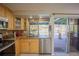 Updated kitchen with stainless appliances, granite counters, and a view of the outdoor living area at 4381 Northshore Dr, Punta Gorda, FL 33980