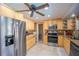 Modern kitchen with stainless steel appliances and wooden cabinets providing ample storage at 4381 Northshore Dr, Punta Gorda, FL 33980