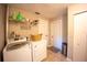 Laundry room with appliances, storage, and convenient access to closet and entry at 4381 Northshore Dr, Punta Gorda, FL 33980