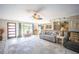 Inviting living room featuring a ceiling fan, large windows and a view into the dining area at 4381 Northshore Dr, Punta Gorda, FL 33980