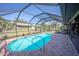 Gorgeous screened-in pool offers a refreshing oasis with lush landscaping, outdoor cooking and relaxation at 4381 Northshore Dr, Punta Gorda, FL 33980